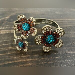 Three flower designs with gems bronze bracelet.